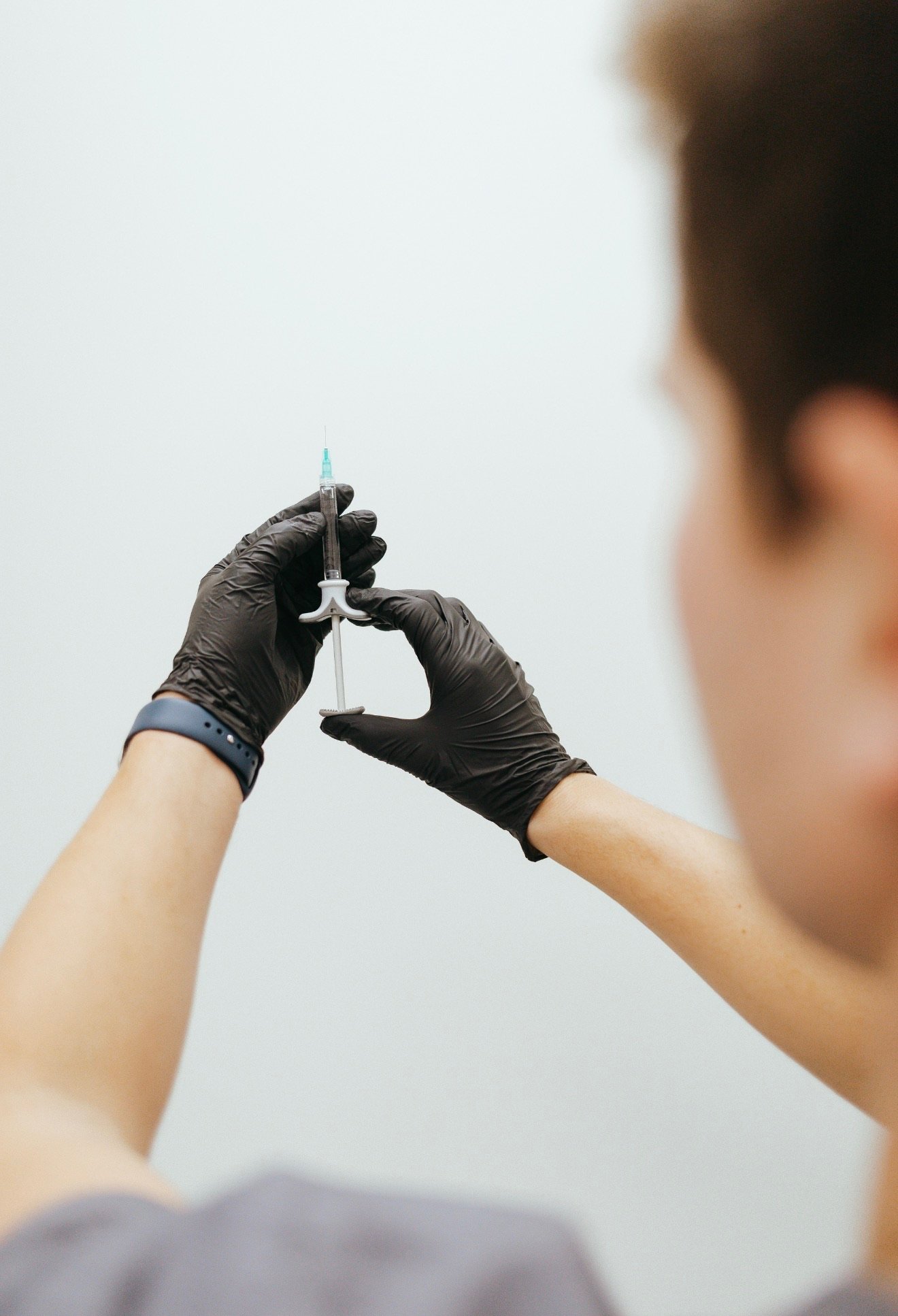A clinician preparing an aesthetics treatment