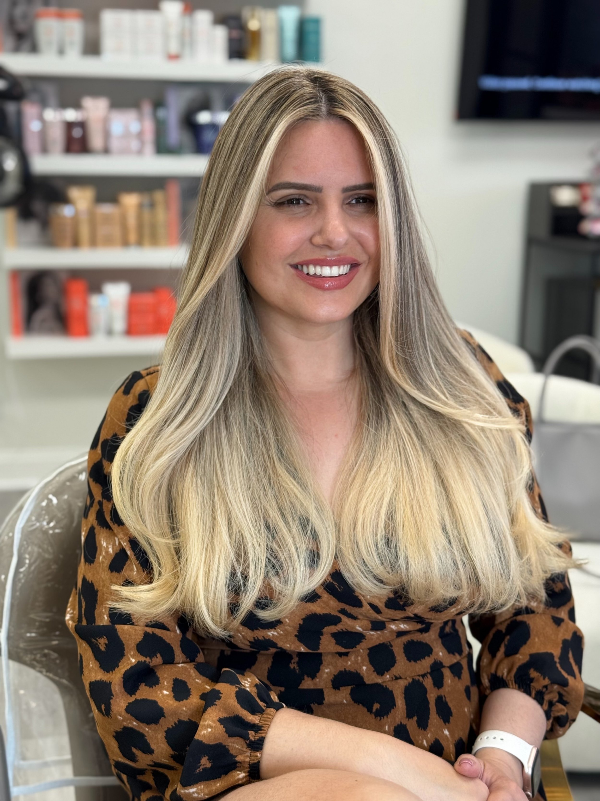 Long bright blonde hair styled with soft face-framing layers