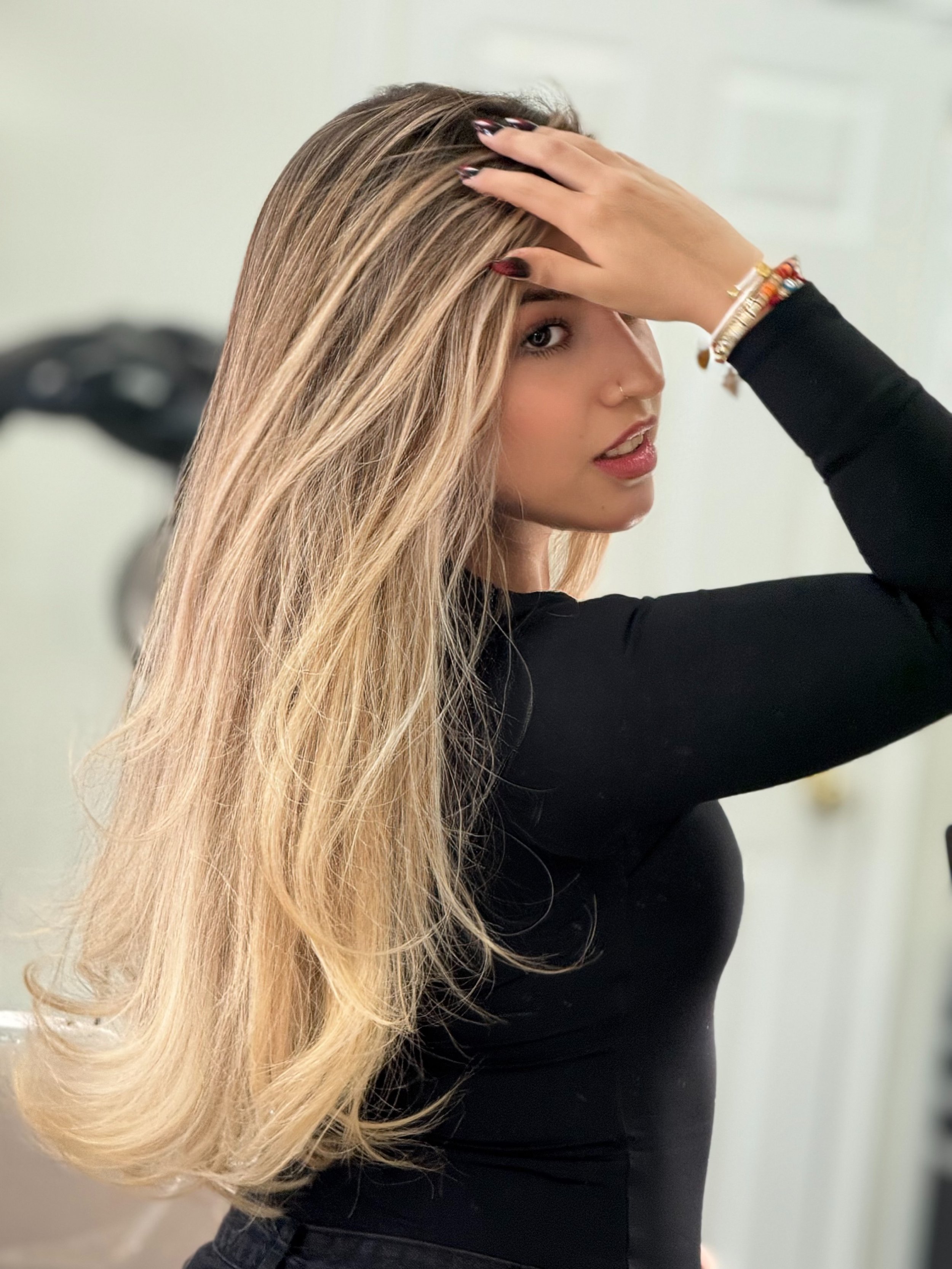 Long balayage hair with a dark root melt and bright blonde ends